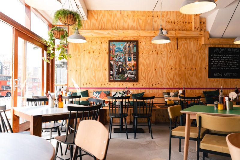 Interior of Rudy's Clapham Junction featuring dining tables, seating, and a warm restaurant atmosphere.